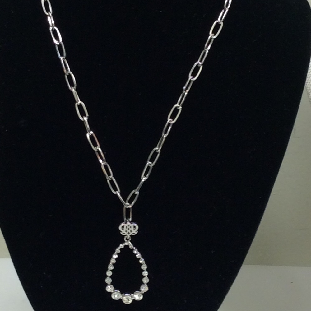 Silvertone with a rhinestone teardrop pendant.